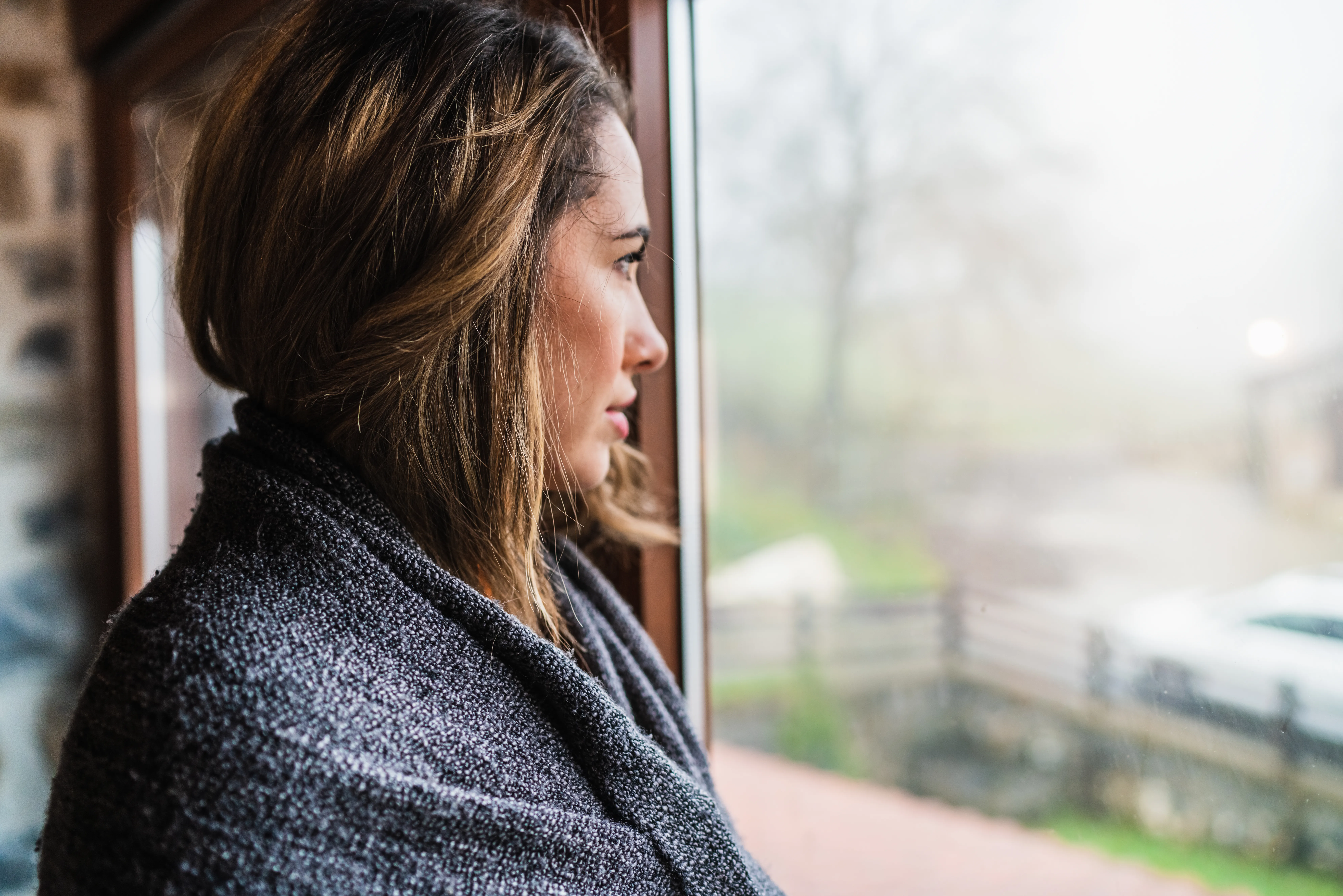 Woman pausing thoughtfully in a calm, quiet moment