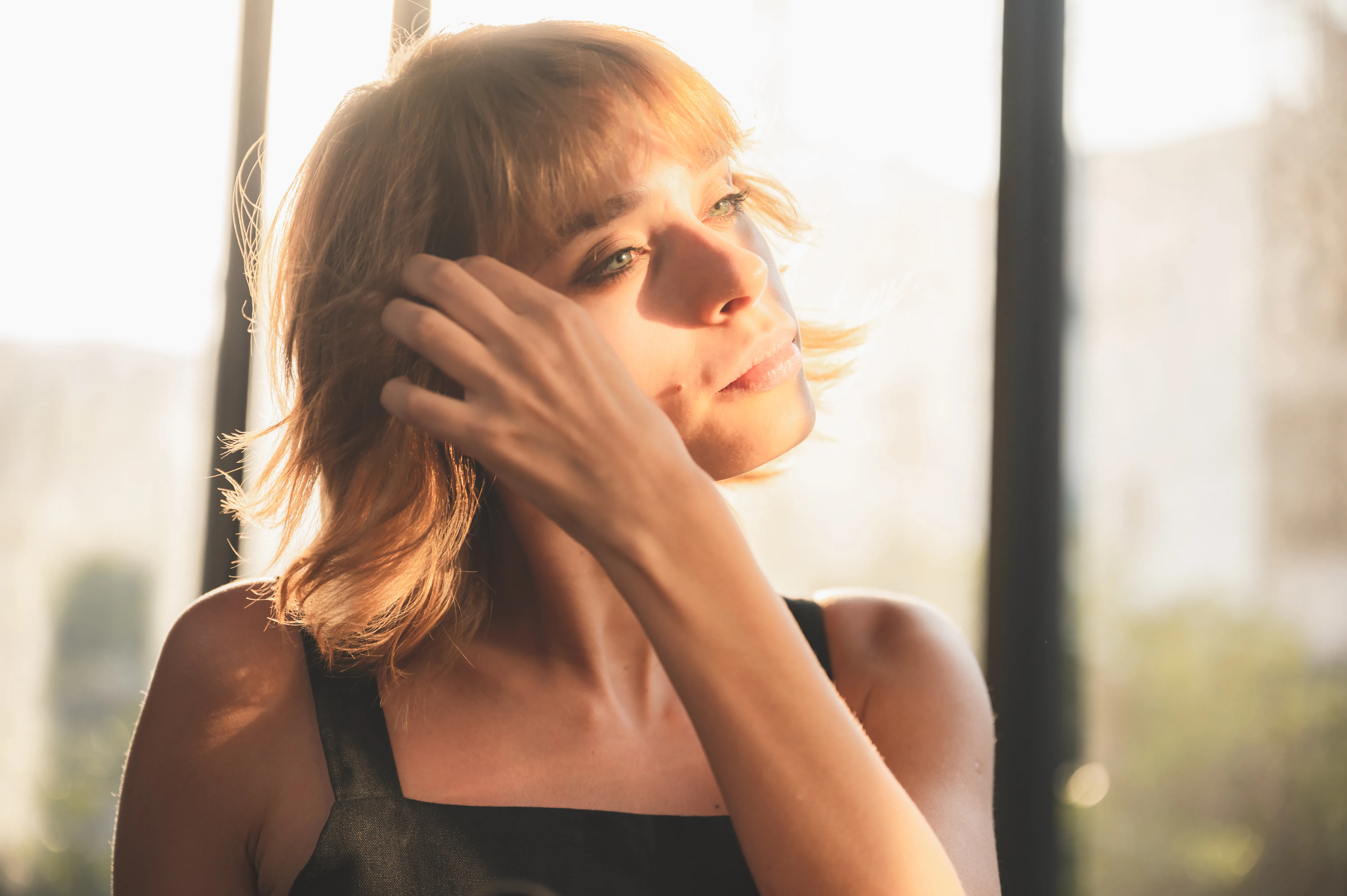 Woman in a quiet, reflective moment, taking a pause in natural light